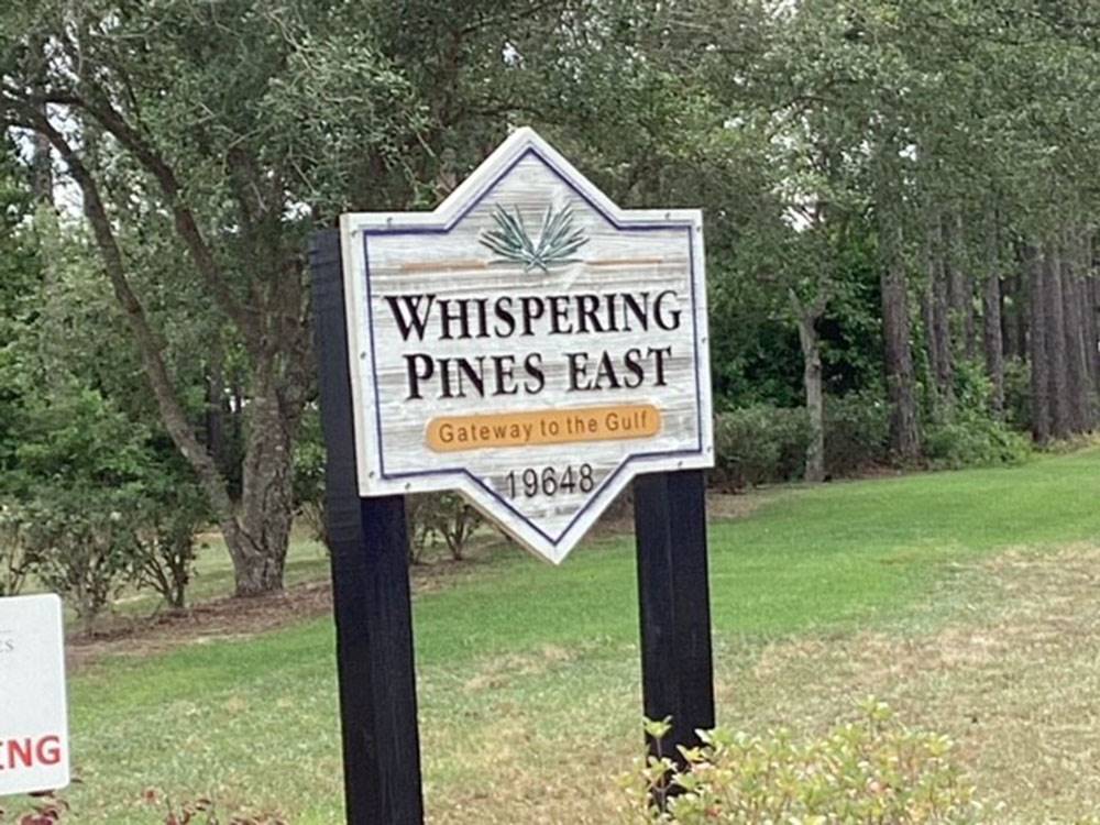 The front entrance sign at Whispering Pines RV Resort East and West