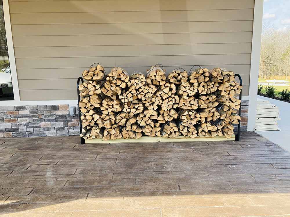 A stack of firewood for sale at WHISPERING FALLS RV PARK AND STORE