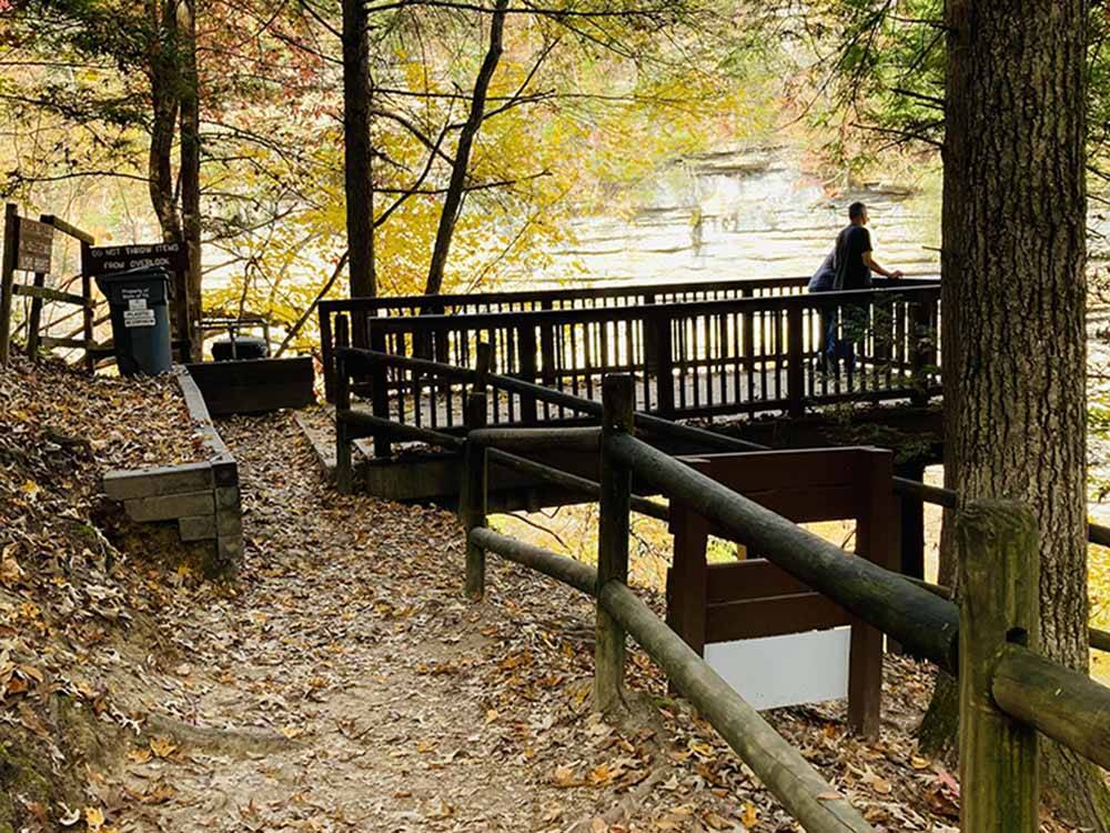 A wooden overlook at the river at WHISPERING FALLS RV PARK AND STORE