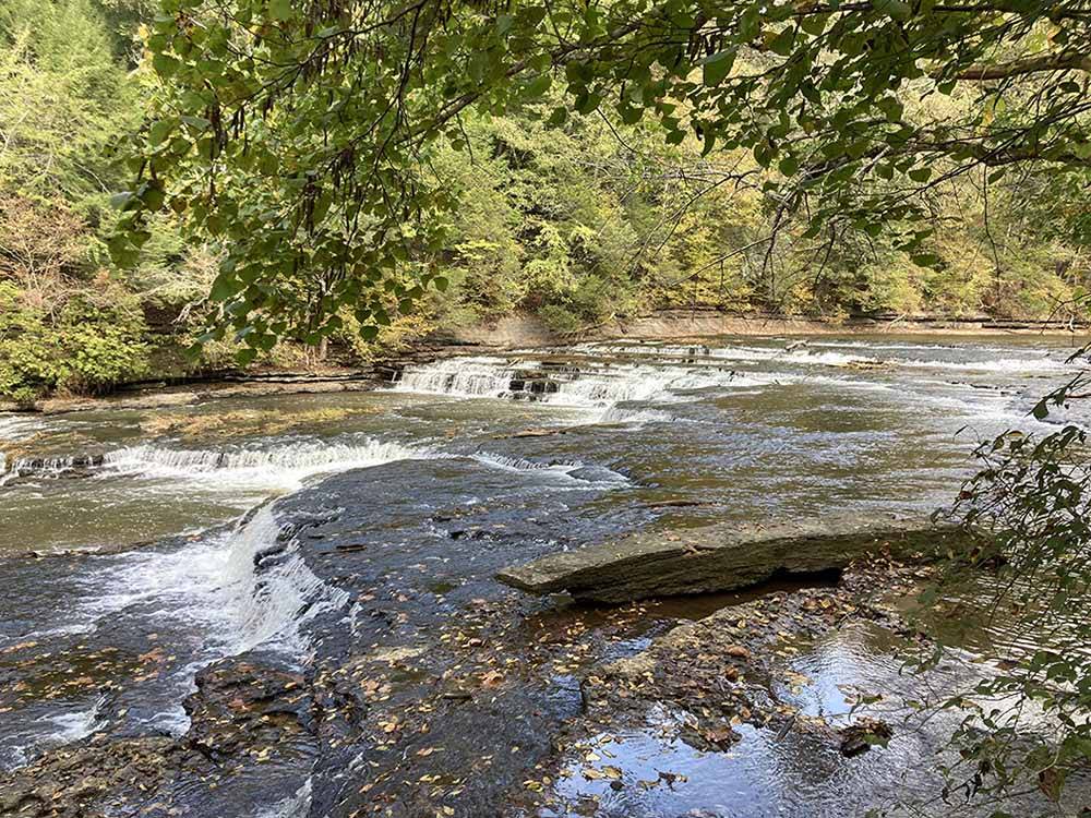 The rushing river nearby at WHISPERING FALLS RV PARK AND STORE