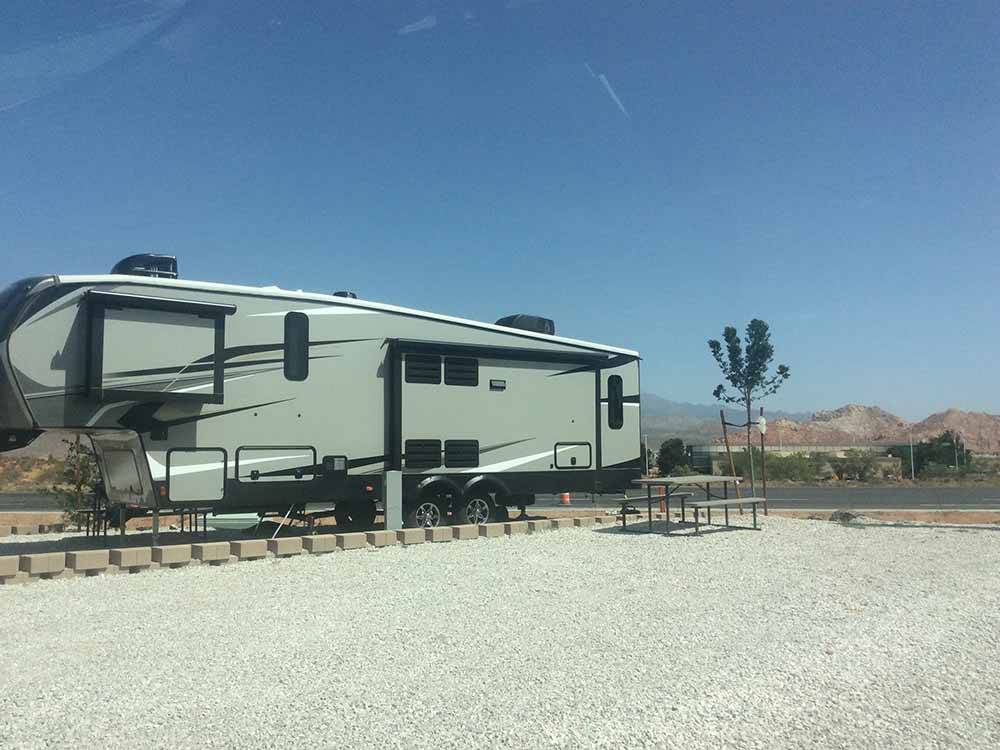 A fifth wheel trailer in an RV site at SAND HOLLOW RV RESORT