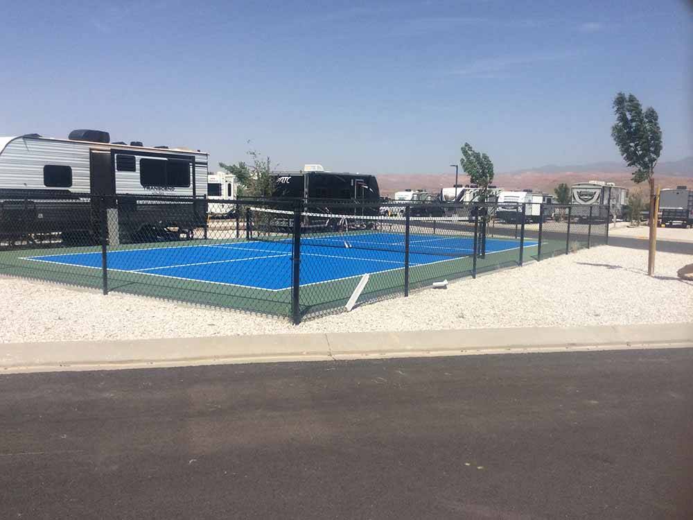 The blue pickleball court next to an RV site at SAND HOLLOW RV RESORT