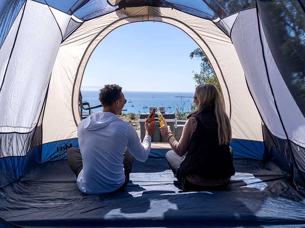 Couple enjoying drinks inside a tent at FLYING FLAGS AVILA BEACH