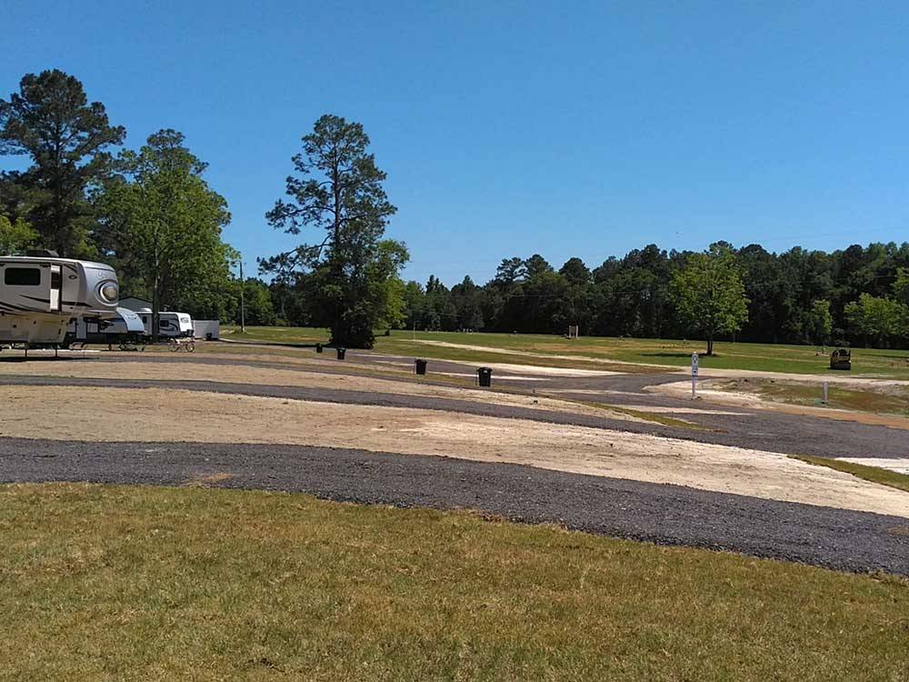 A view of empty paved RV sites at PEBBLE HILL RV RESORT
