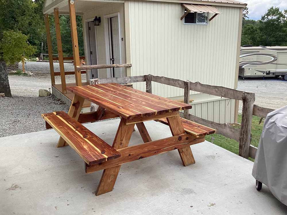 A picnic bench next to the restrooms at KELLER'S KOVE CABIN AND RV RESORT