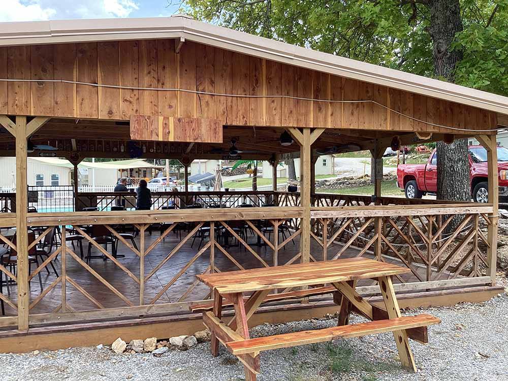 A picnic bench next to the pavilion at KELLER'S KOVE CABIN AND RV RESORT