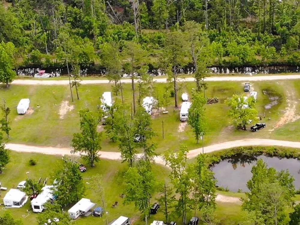 An aerial view of the grassy RV sites at AT EASE CAMPGROUND & MARINA