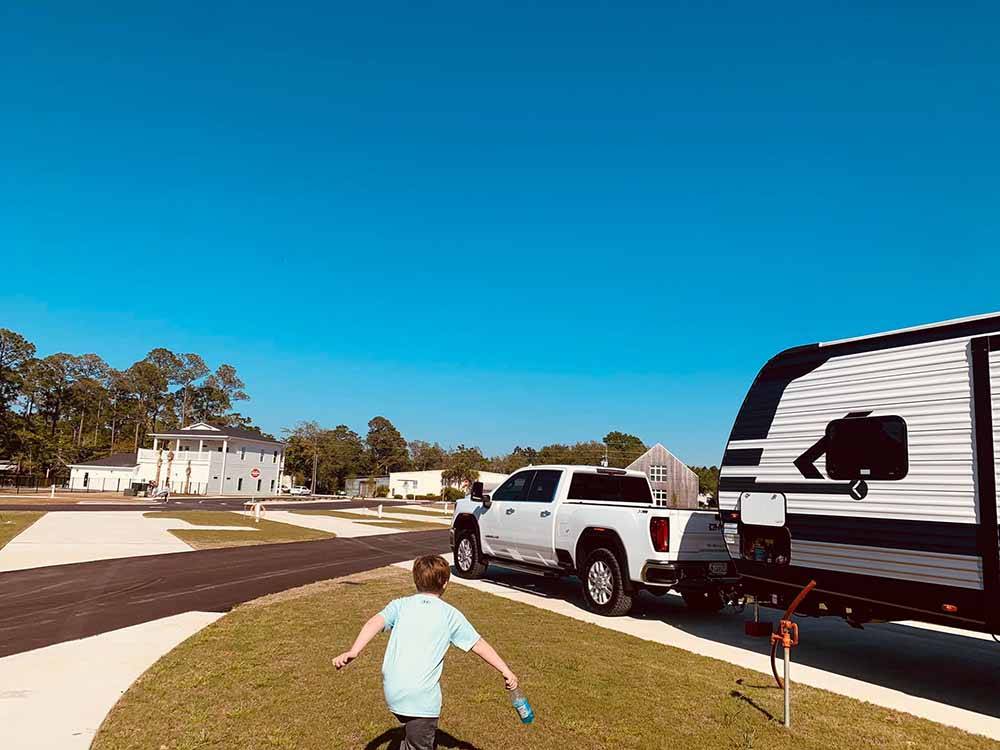 A kid playing in an RV site at 30A LUXURY RV RESORT