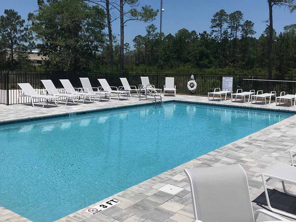 The swimming pool with lounge chairs at 30A LUXURY RV RESORT