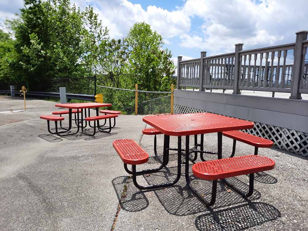A couple of red picnic tables at MEDALLION CAMPGROUND - BRISTOL MOTOR SPEEDWAY