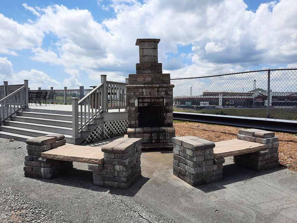 A fire place and stone benches at MEDALLION CAMPGROUND - BRISTOL MOTOR SPEEDWAY