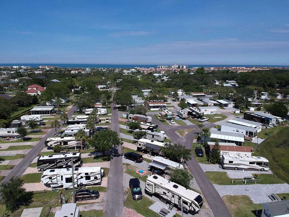 RVs on lots with ocean background at OCEAN GROVE RV RESORT