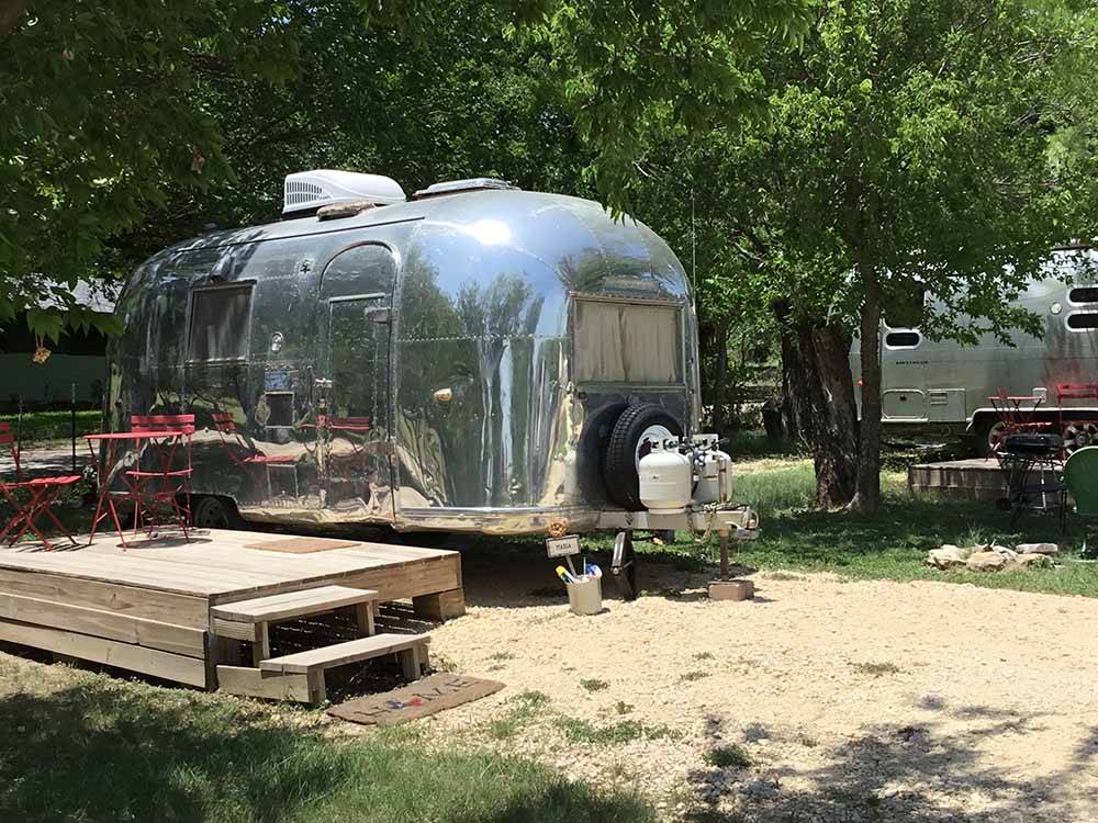 Small Airstream in a sandy campsite at OFF THE VINE RV PARK