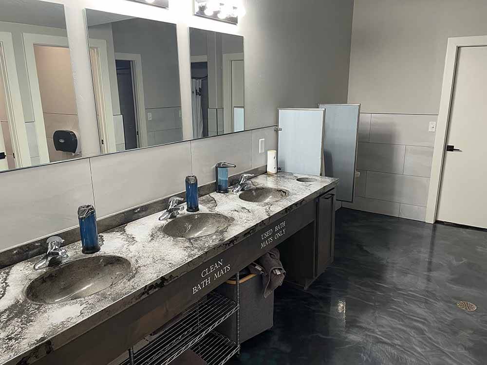 Inside of the clean and modern restroom at ROLLIN' HOME RV PARK