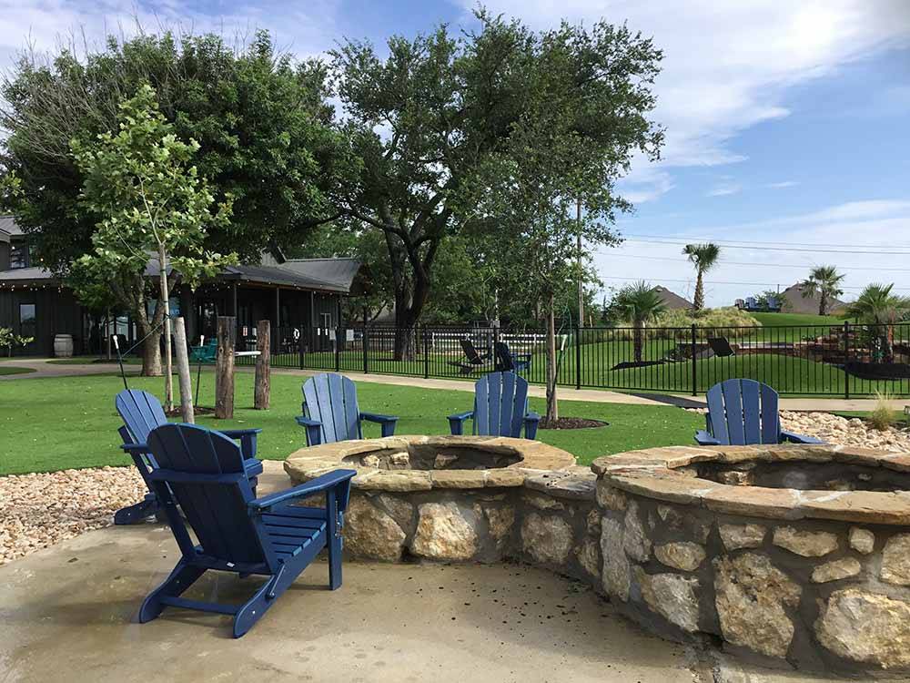 Blue chairs around the fire pits at BUDA PLACE RV RESORT
