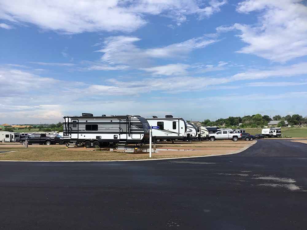 A row of travel trailers in RV sites at BUDA PLACE RV RESORT