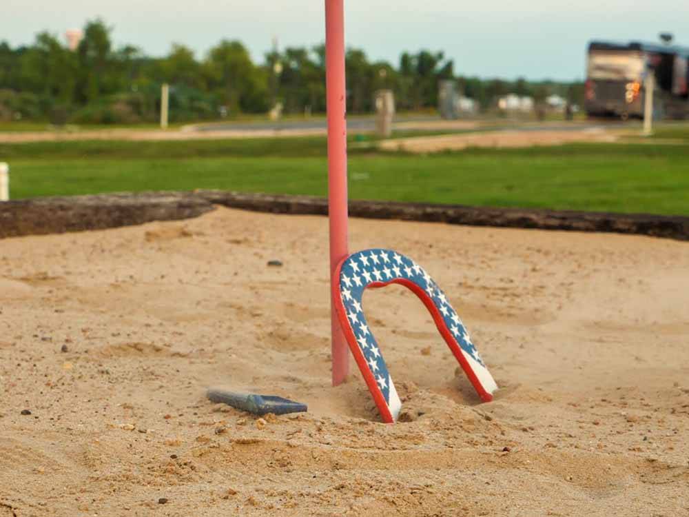 A horseshoe with stars in the sand at BUDA PLACE RV RESORT