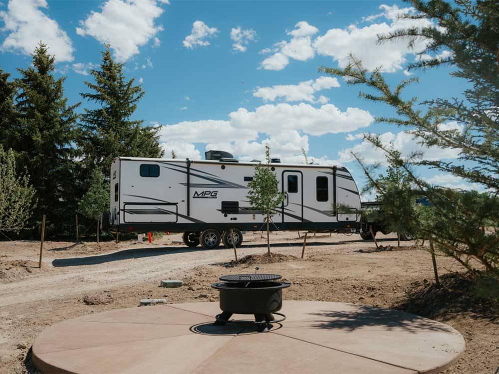 A fifth wheel trailer parked in a gravel site at LITTLE AMERICA RV PARK