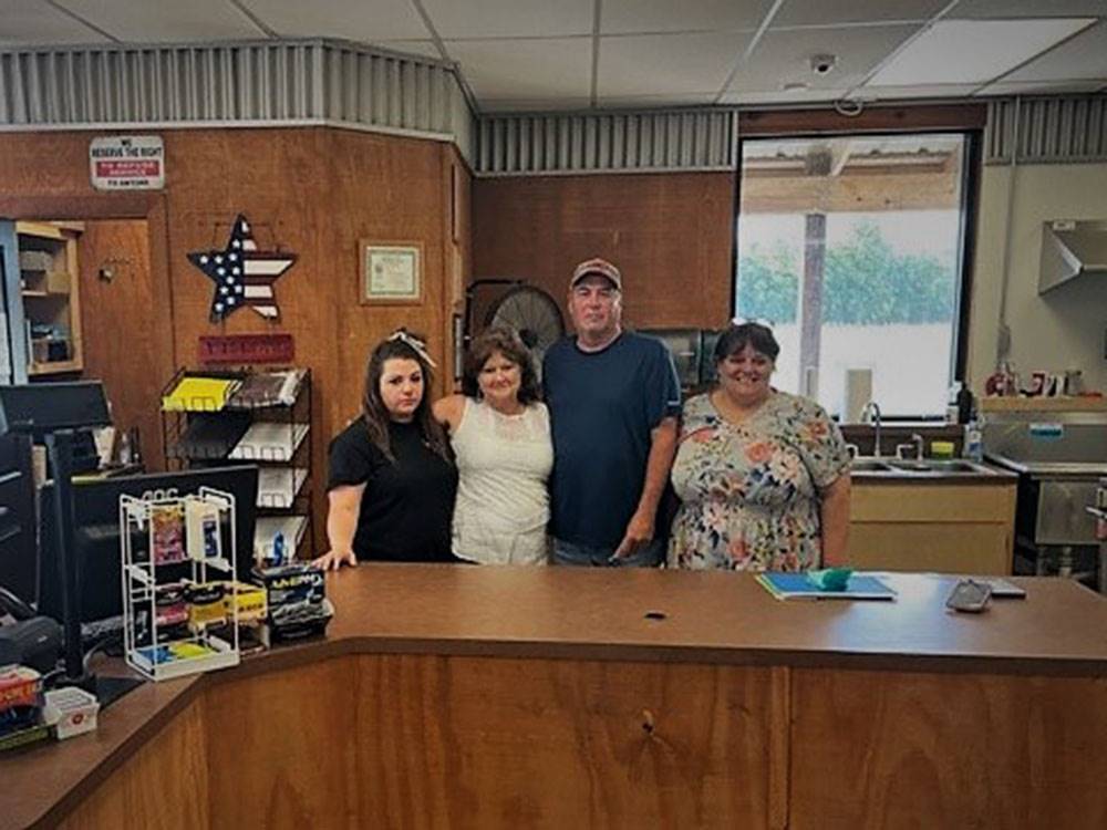 Employees standing behind the desk at SUGAR VALLEY RV RESORT BY RJOURNEY