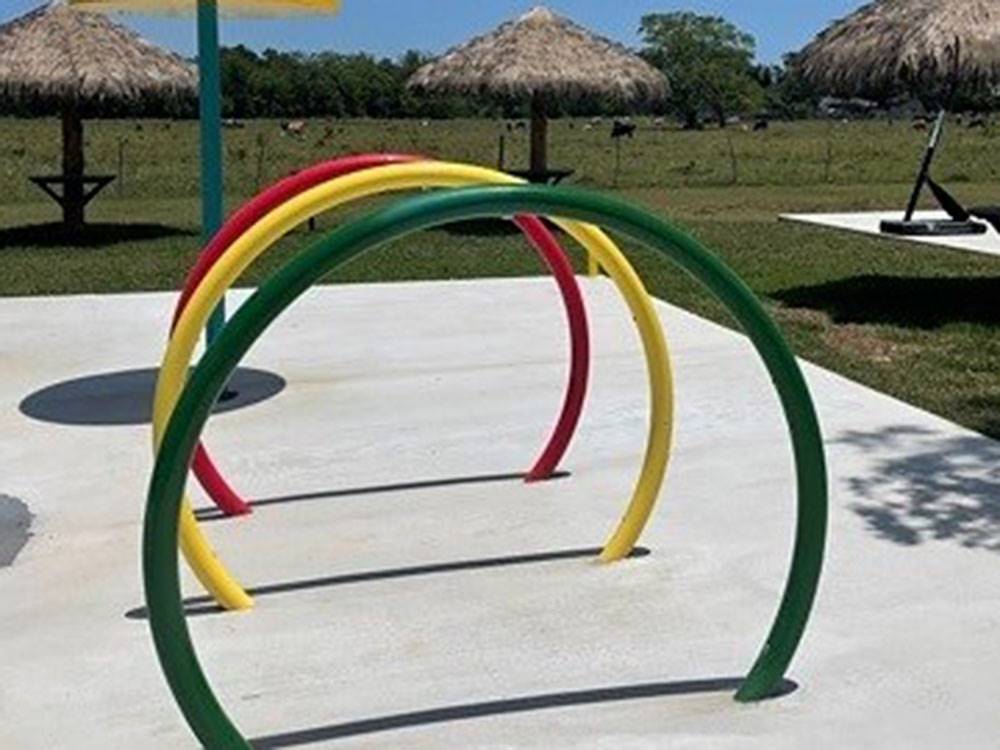 Colorful rings at the splash pad at SUGAR VALLEY RV RESORT BY RJOURNEY