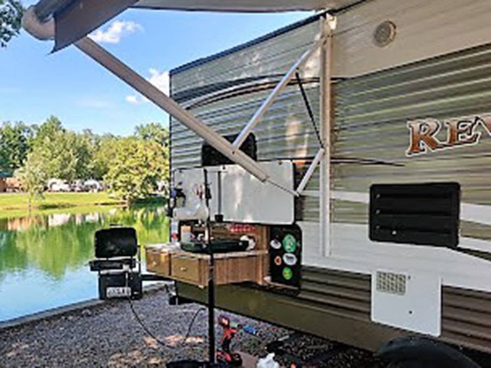 RV parked by the lake at SPLASH MAGIC RV RESORT BY RJOURNEY