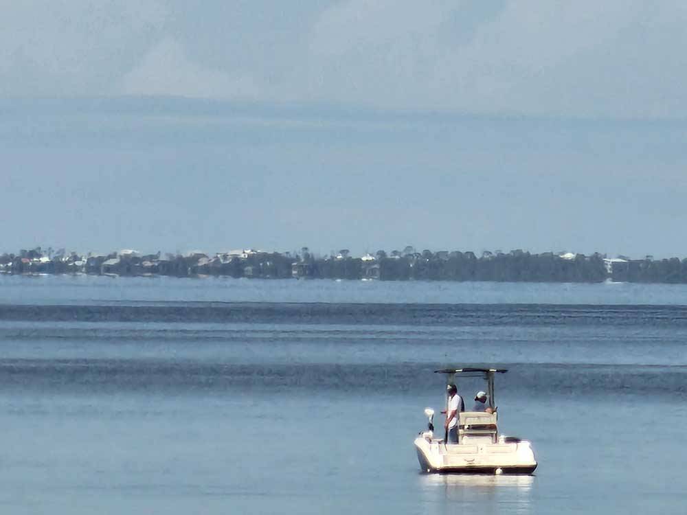 Two men in a boat in the water at PORT ST JOE RV RESORT