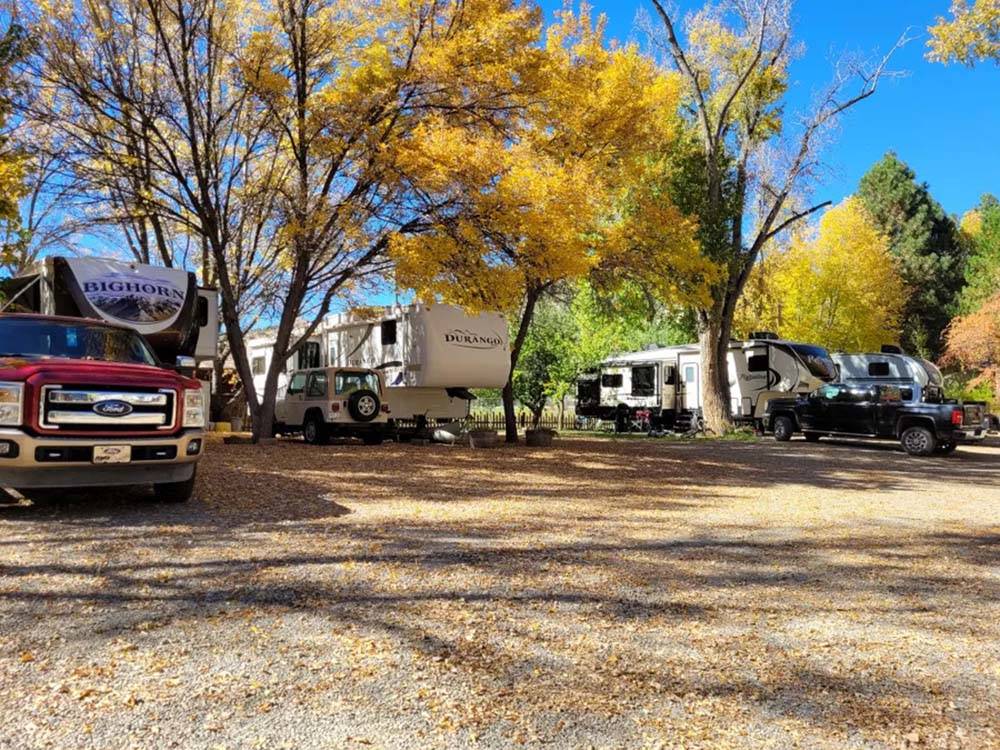 A row of fifth wheel trailers parked at OUTPOST MOTEL CABINS AND RV PARK