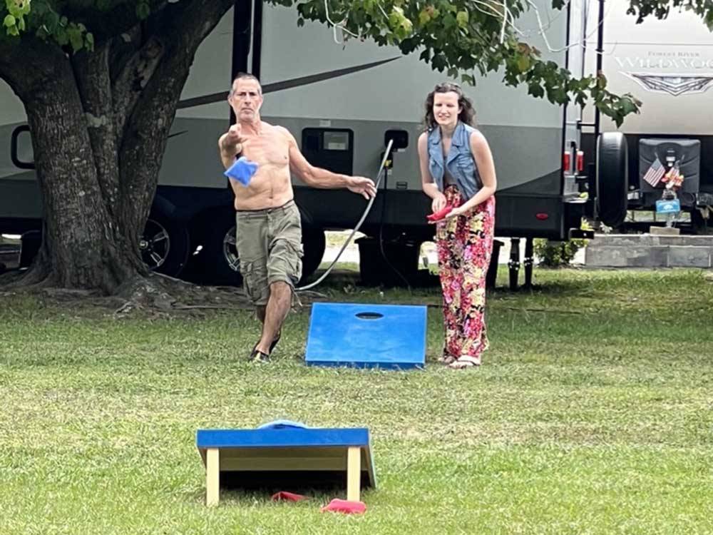 The man throwing the bean bag for corn hole at BUTTON'S FAMILY CAMPGROUND
