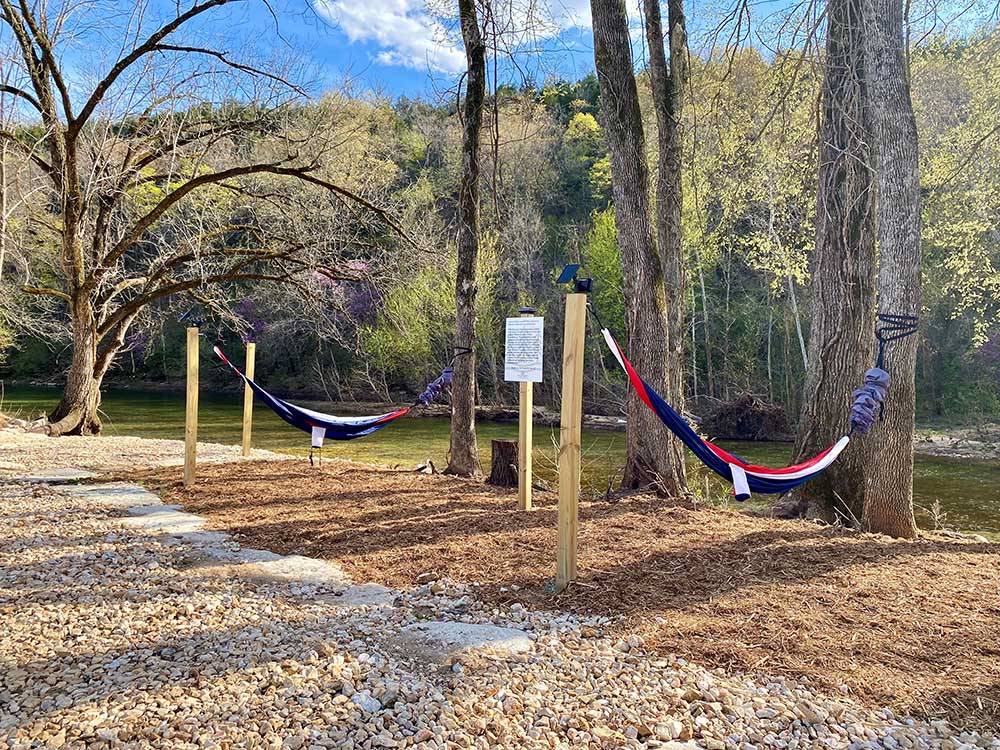 Two red, blue and white hammocks at BULL CREEK RV PARK