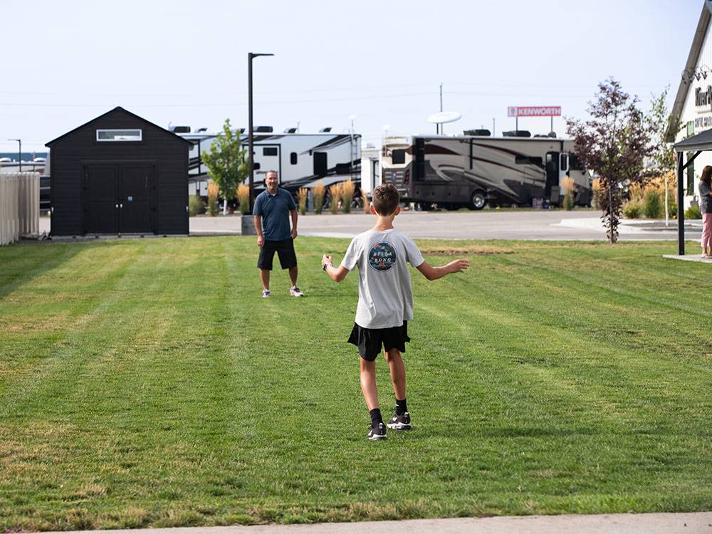 A dad and his son playing frisbee