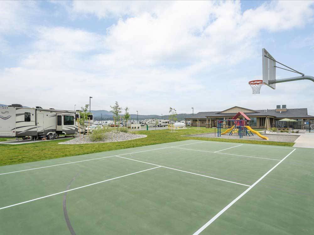 The basketball court next to a RV site at POST FALLS RV CAMPGROUND