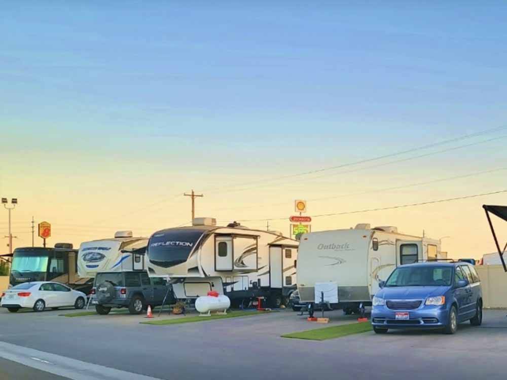 A row of trailers in paved RV sites at CENTER POINT RV PARK