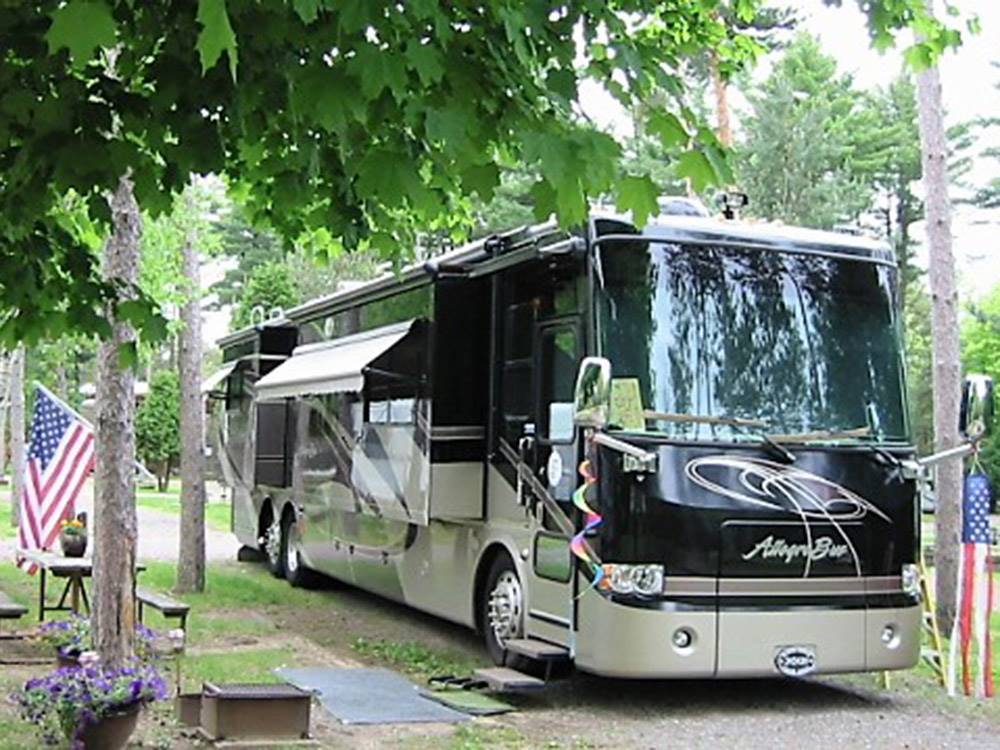 Class A motorhome in a gravel site at ELKHART RV RESORT BY RJOURNEY