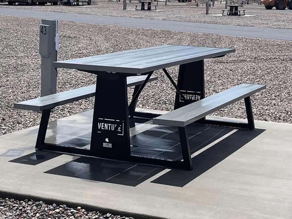Picnic table next to RV site at VENTURE RV PARK