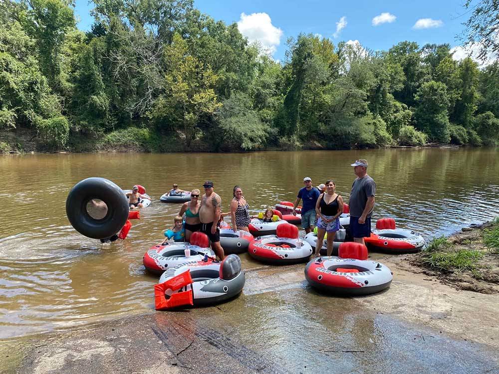 People on the river inner tubing at CHICKASAWHAY RIVER RV PARK
