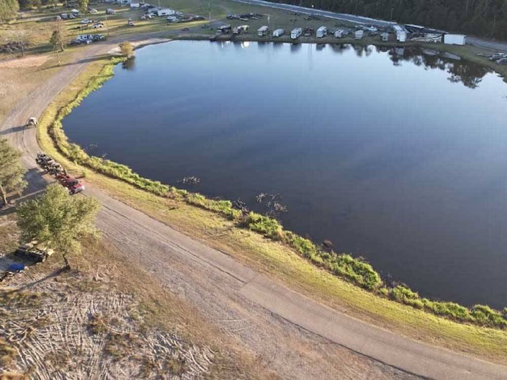 An aerial view of the gravel road by the lake at CHICKASAWHAY RIVER RV PARK