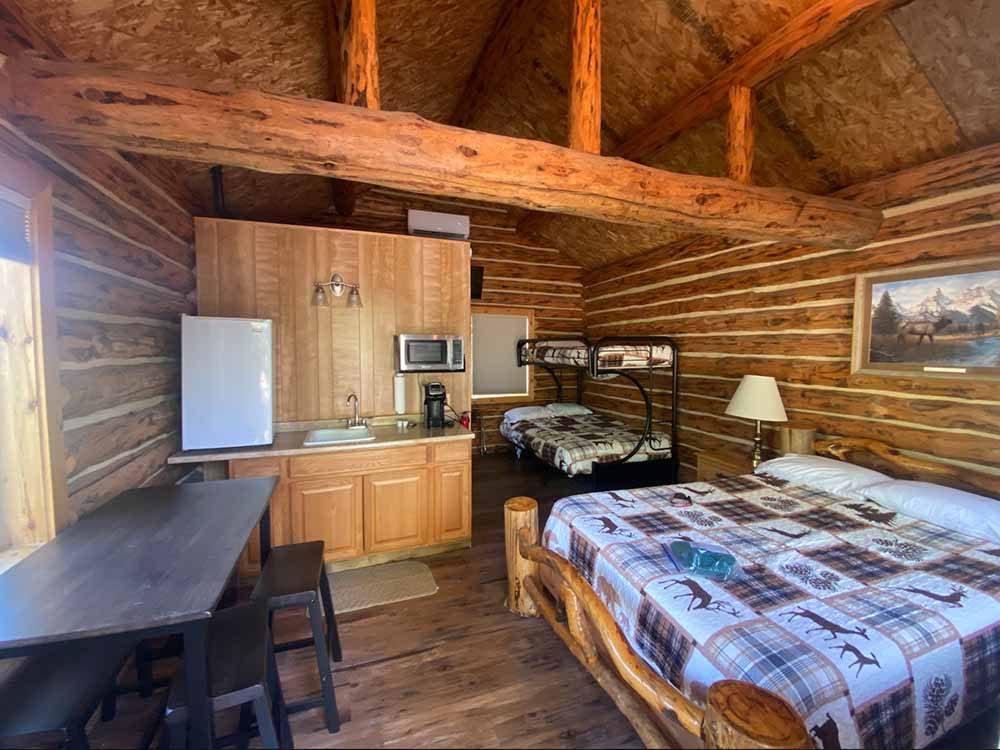 The bed in the rental log cabin at HOVER CAMP