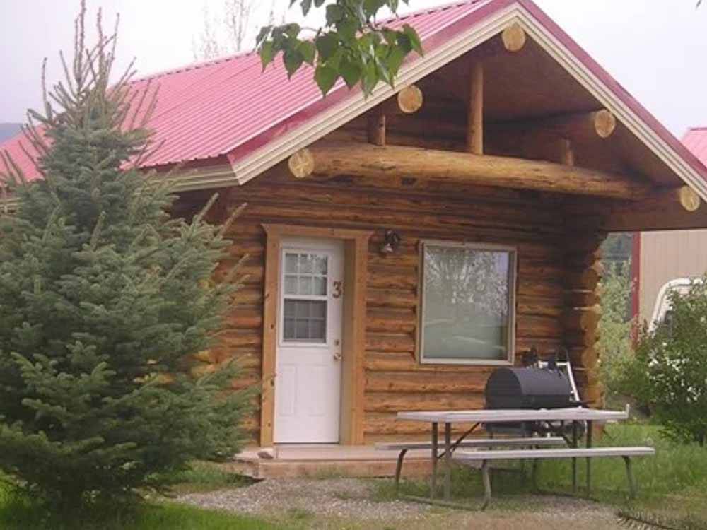 A picnic table in front of the rental cabin at HOVER CAMP