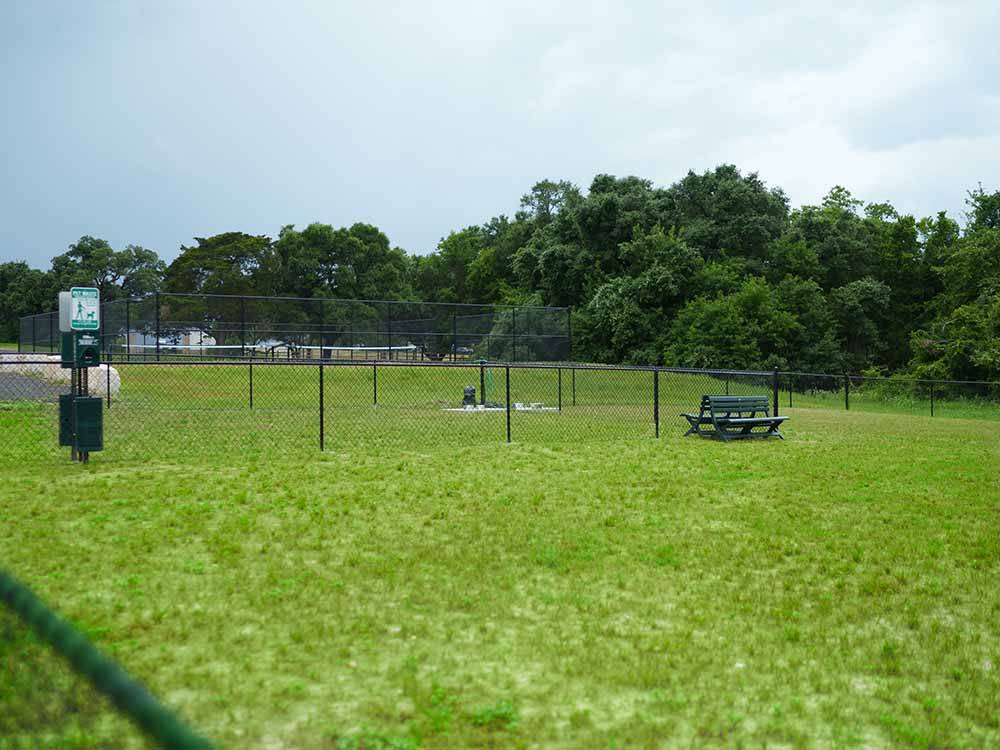 The fenced in pet area at THE HILL TOP AT BRENHAM RV RESORT