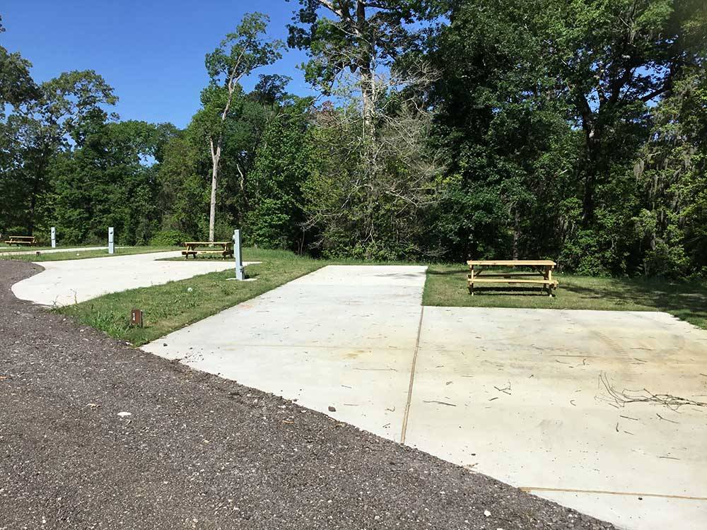 Two empty RV sites with picnic benches at THE PRESERVE RV PARK