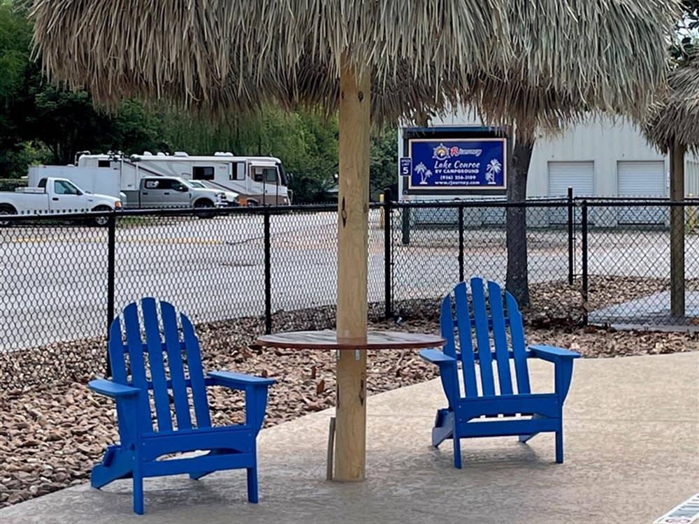 Two lounge chairs under a hut at LAKE CONROE RV CAMPGROUND BY RJOURNEY