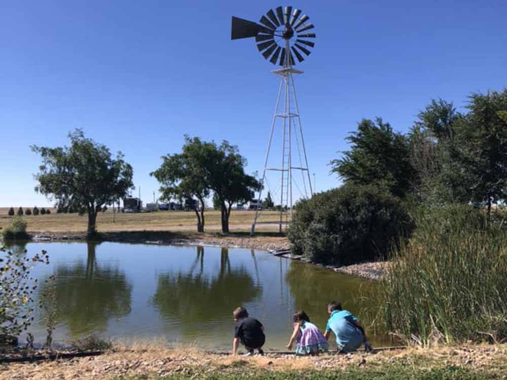 Children playing at the pond at COYOTE KEETH'S RV PARK
