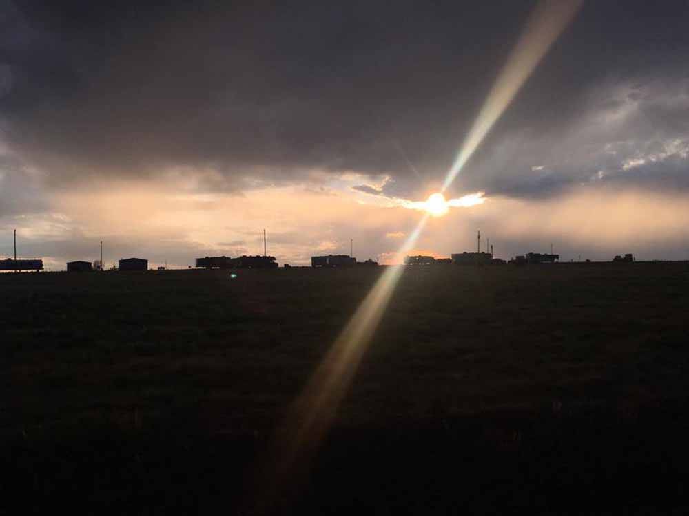 Sun shining through the clouds in the evening at COYOTE KEETH'S RV PARK