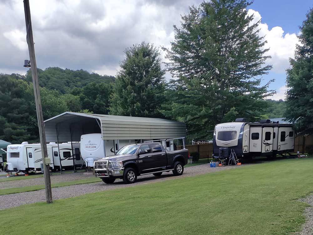 Fifth wheel trailer and truck parked in site at NEW RIVER BRIDGE FAMILY CAMPGROUND