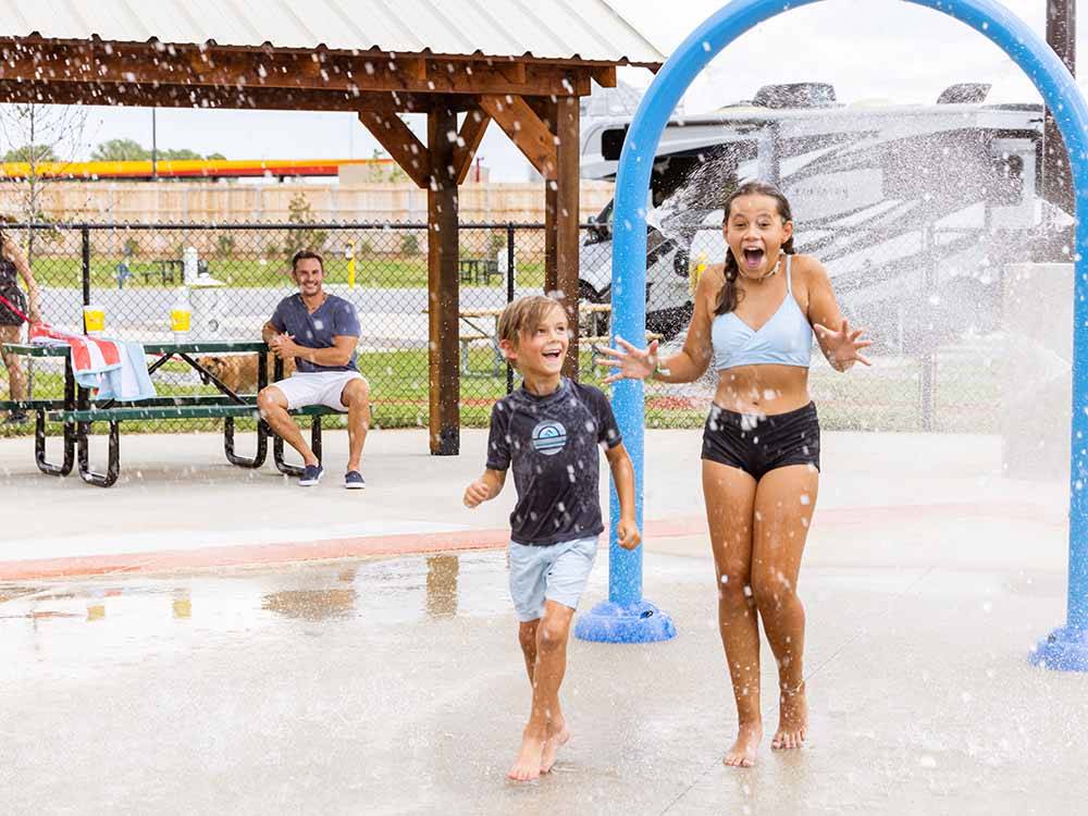 A couple of kids playing in the splash pad at LOVE'S RV STOP - 801
