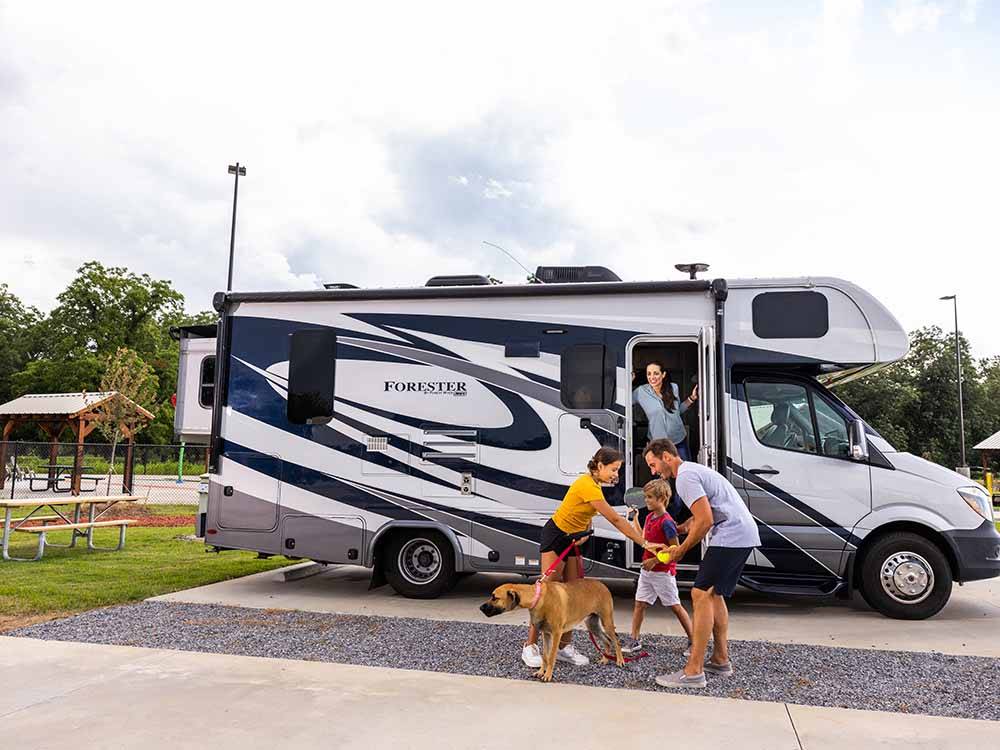 A family and a dog outside of a motorhome at LOVE'S RV STOP - 801