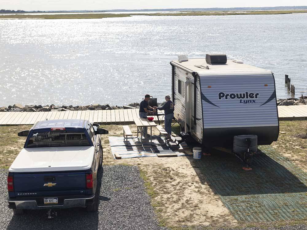 A trailer parked by the water at SUN OUTDOORS CHINCOTEAGUE BAY