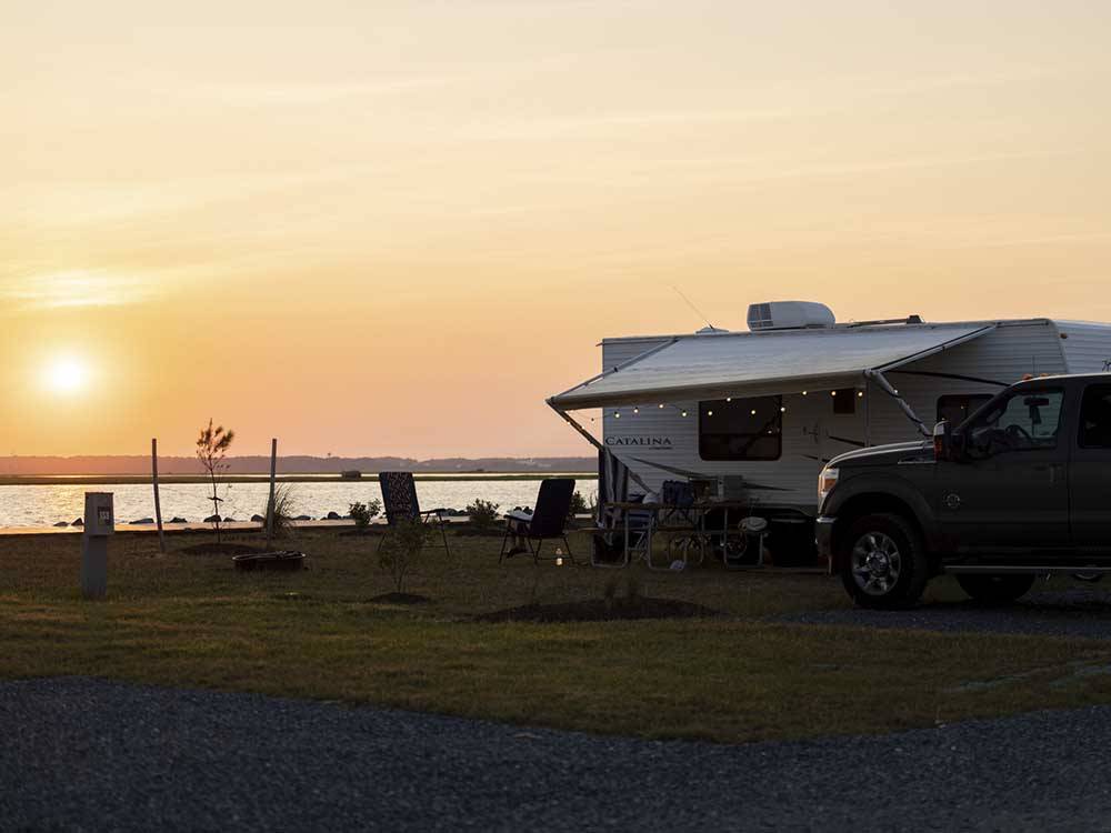 A travel trailer parked under the sunset at SUN OUTDOORS CHINCOTEAGUE BAY