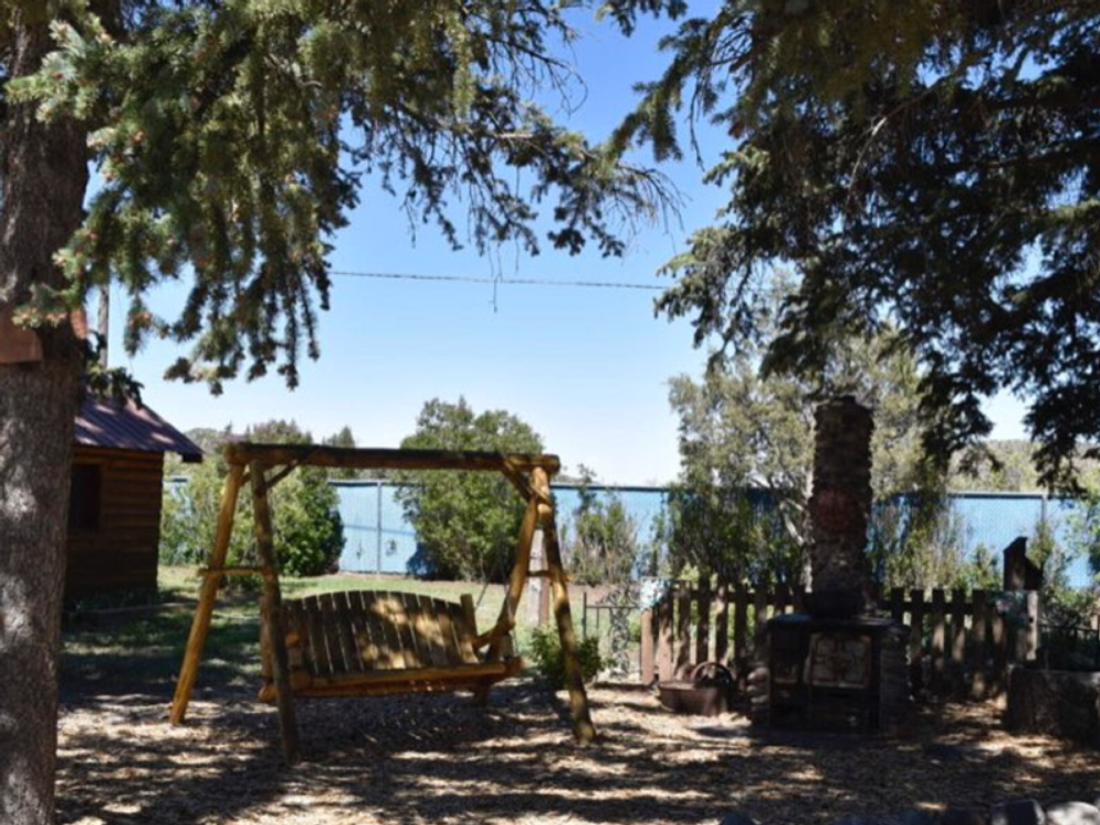 Swing under the trees at Chinook Cabins & RV Park