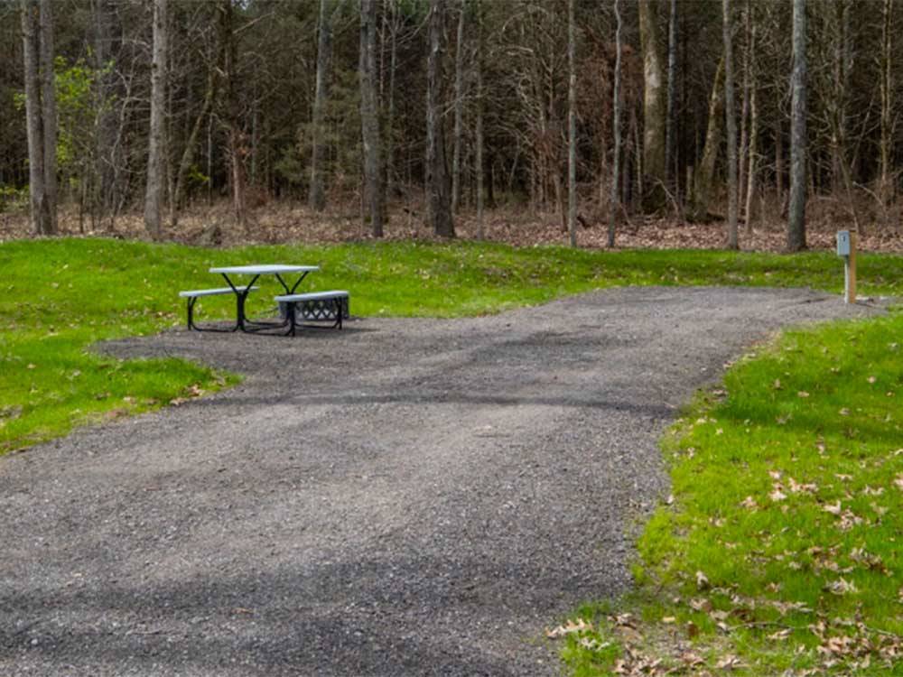 A empty gravel site with a picnic bench at RURAL HILL FARM